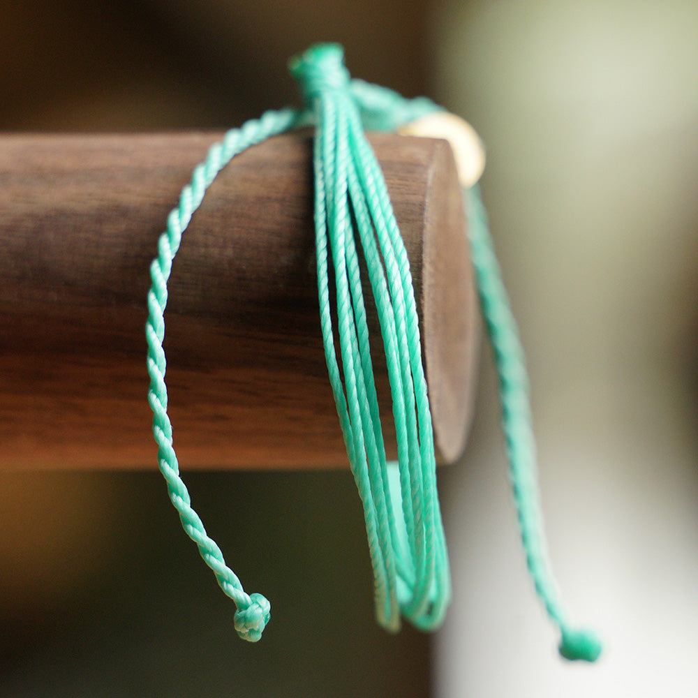 PULSERA AJUSTABLE HILO ENCERADO “COSMICA ORIGINAL TURQUESA”