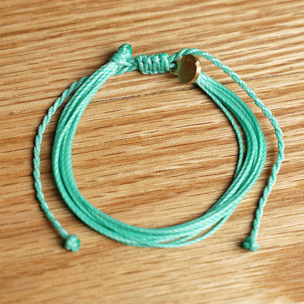 PULSERA AJUSTABLE HILO ENCERADO “COSMICA ORIGINAL TURQUESA”